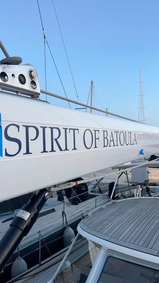 Navy cut-vinyl yacht name 'Spirit of Batoula' on a white racing-yacht hull in a Mallorca marina